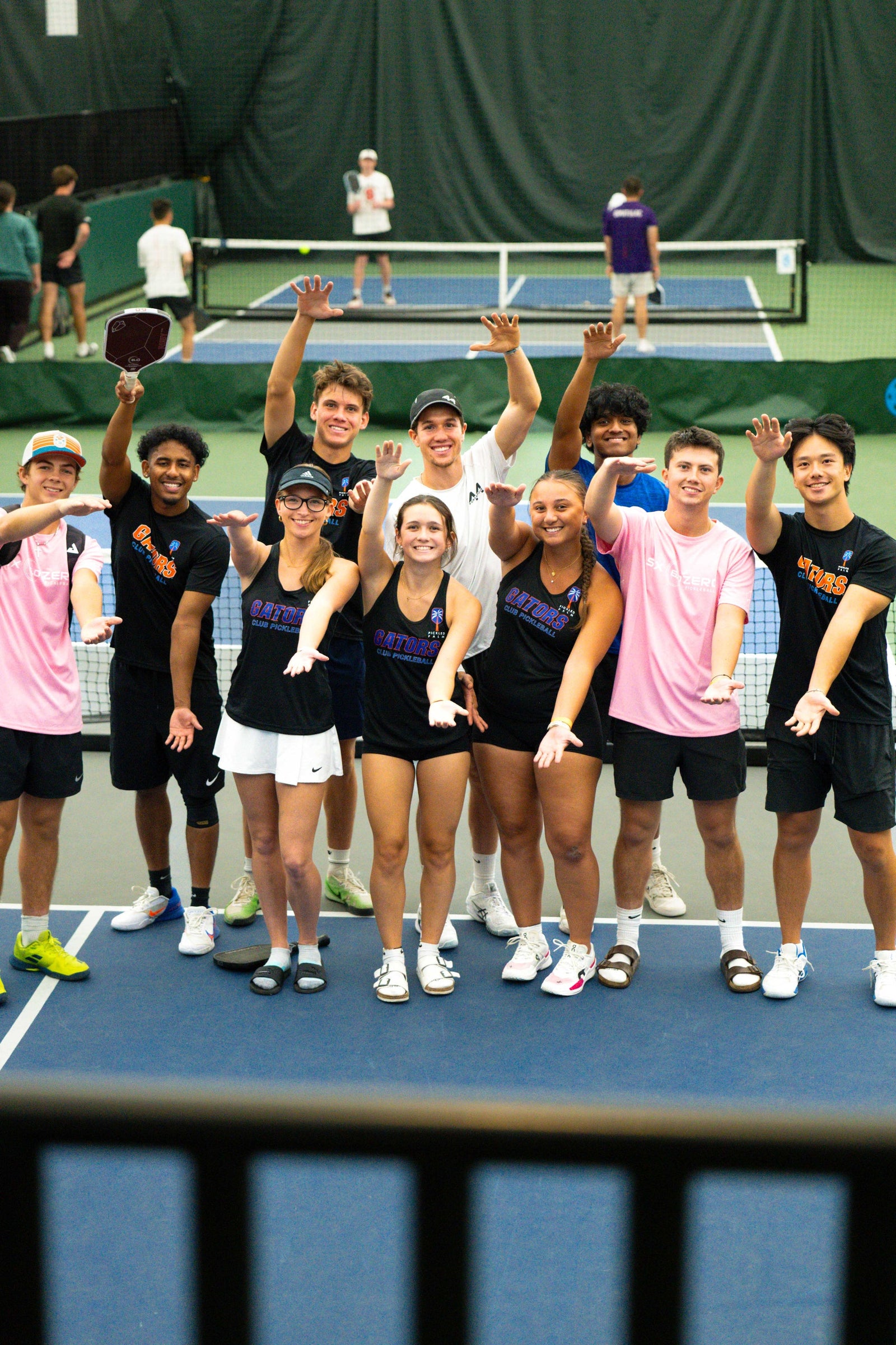 A college pickleball team with custom paddles