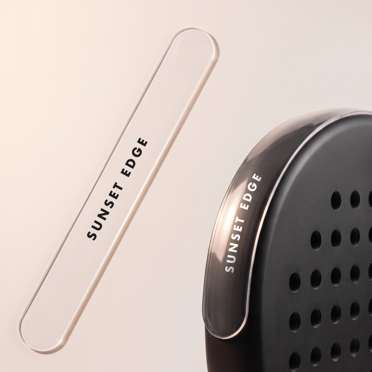 A clear straight frame protector beside a black padel racket, and covering the whole edge of its frame