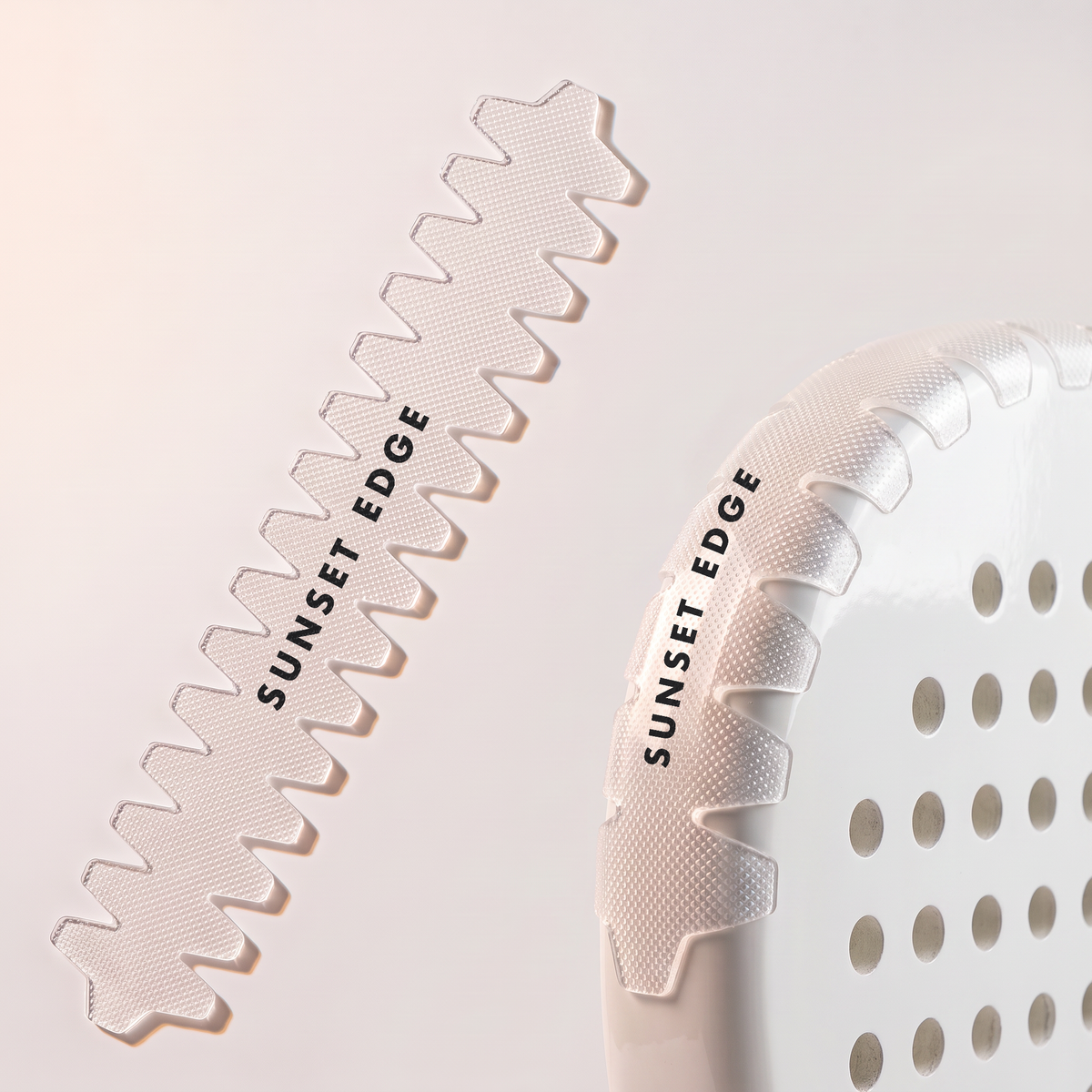 A clear toothed frame protector with a black logo, beside and fitted on a white padel racket